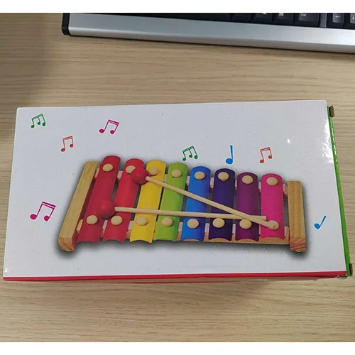 Hand knocks the xylophone