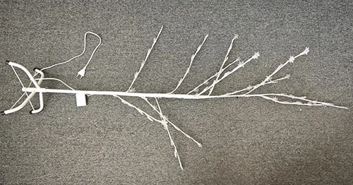 Illuminated tree with plastic end of LED light sources in the shape of a snowflake